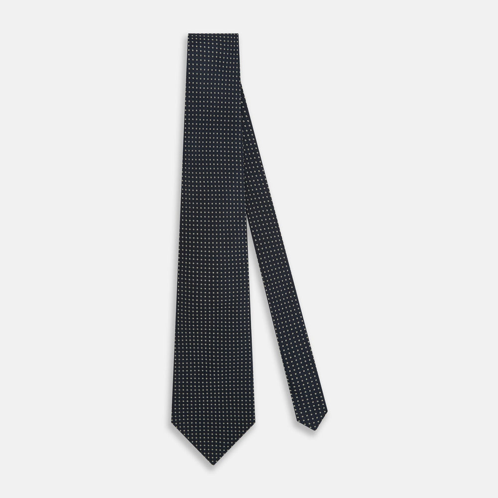 The Navy and White Square Silk Tie by Turnbull & Asser is crafted from English silk with a subtle white square pattern, rolled tip-forward and displayed on a white background for a tailored look.