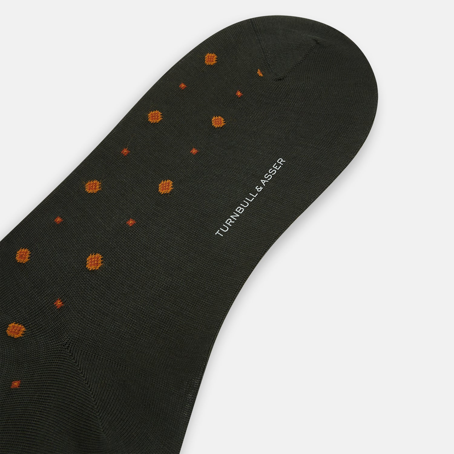 View 3 of product A single Turnbull & Asser Forest Green Patterned Mid-Length Sock with orange polka dots is displayed upright against a plain white background.