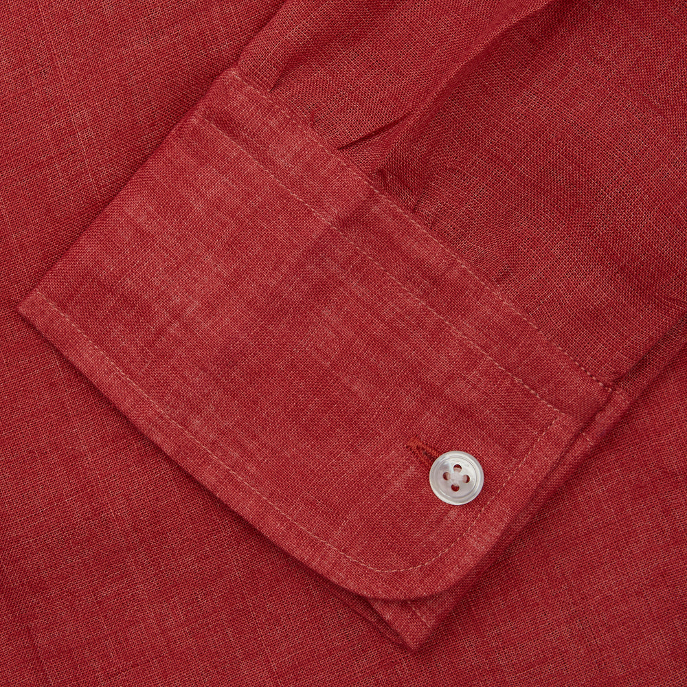 The Turnbull & Asser Plain Red Linen Weekend Fit Shirt with Stand Collar features long sleeves, a button-up front, and two buttoned-flap chest pockets. It is shown neatly laid flat on a plain light background.