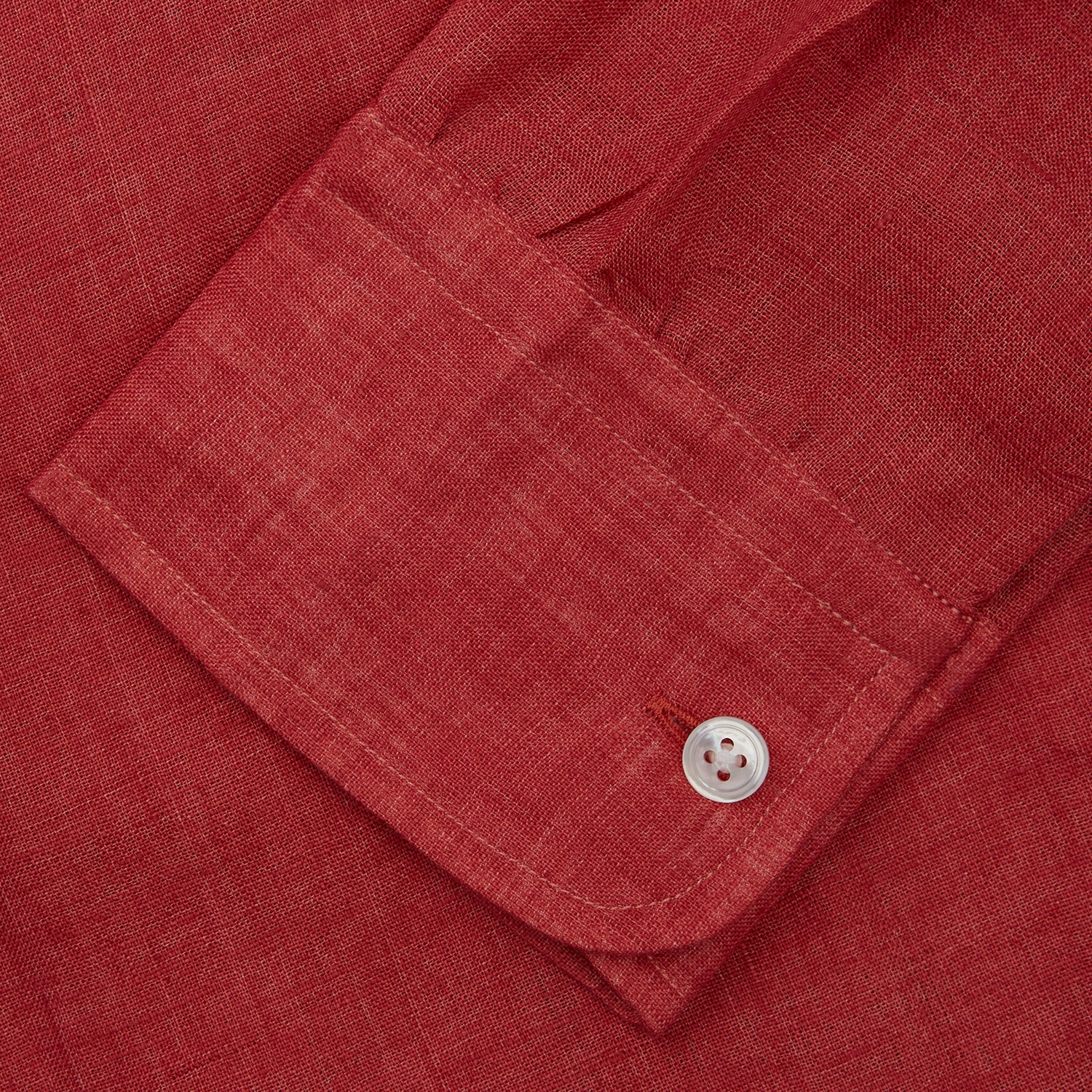 View 5 of product The Turnbull & Asser Plain Red Linen Weekend Fit Shirt with Stand Collar features long sleeves, a button-up front, and two buttoned-flap chest pockets. It is shown neatly laid flat on a plain light background.