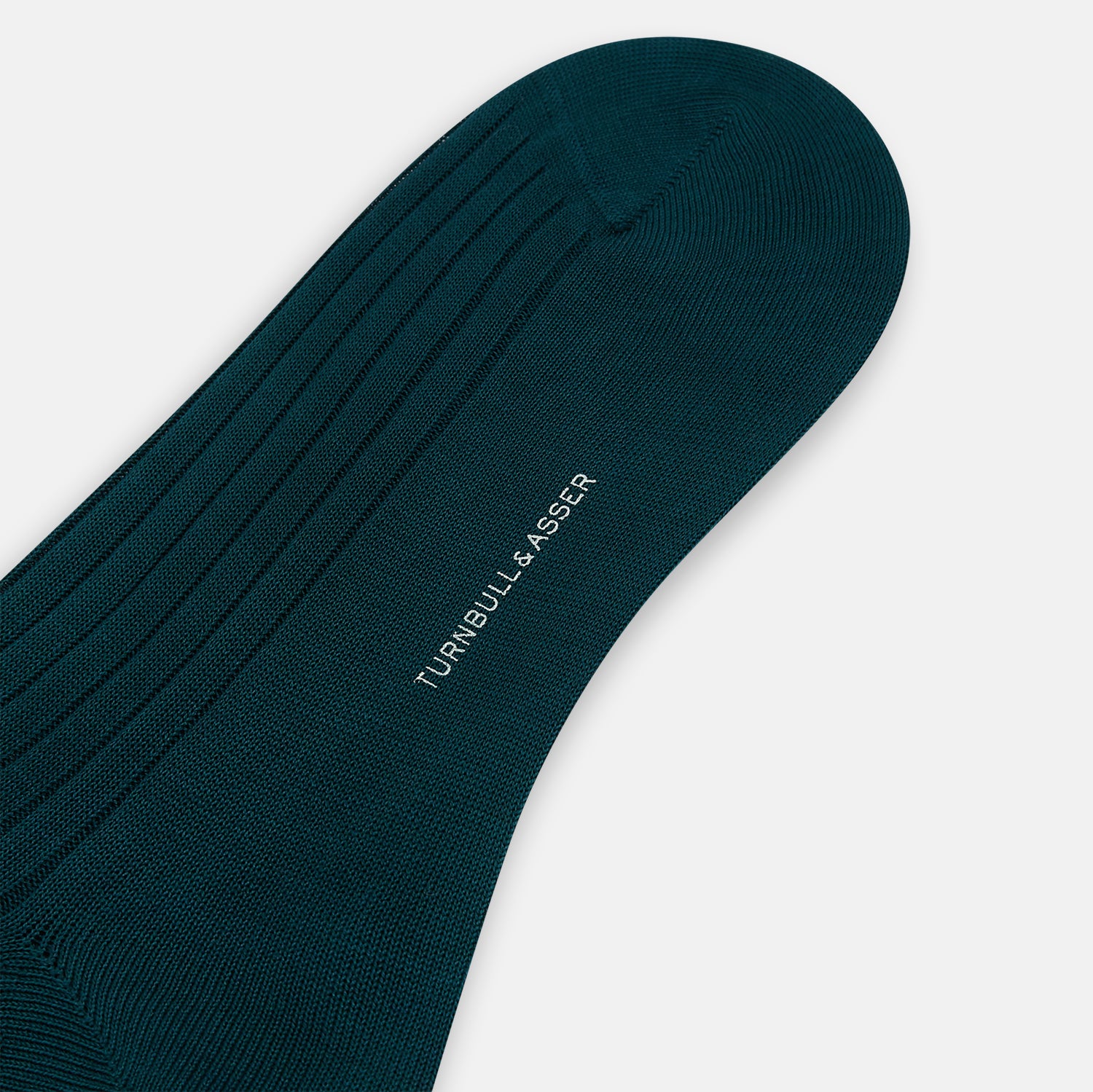 View 3 of product A single Forest Green Thick Knit Mid-Length Sock by Turnbull & Asser, crafted from mercerised Egyptian cotton with ribbed texture, stands upright on a white background, showing its side profile from heel to toe.