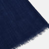 View 2 of product The Turnbull & Asser Navy Cashmere Scarf features a subtle texture and frayed edges, loosely knotted at the top and displayed against a plain white background.