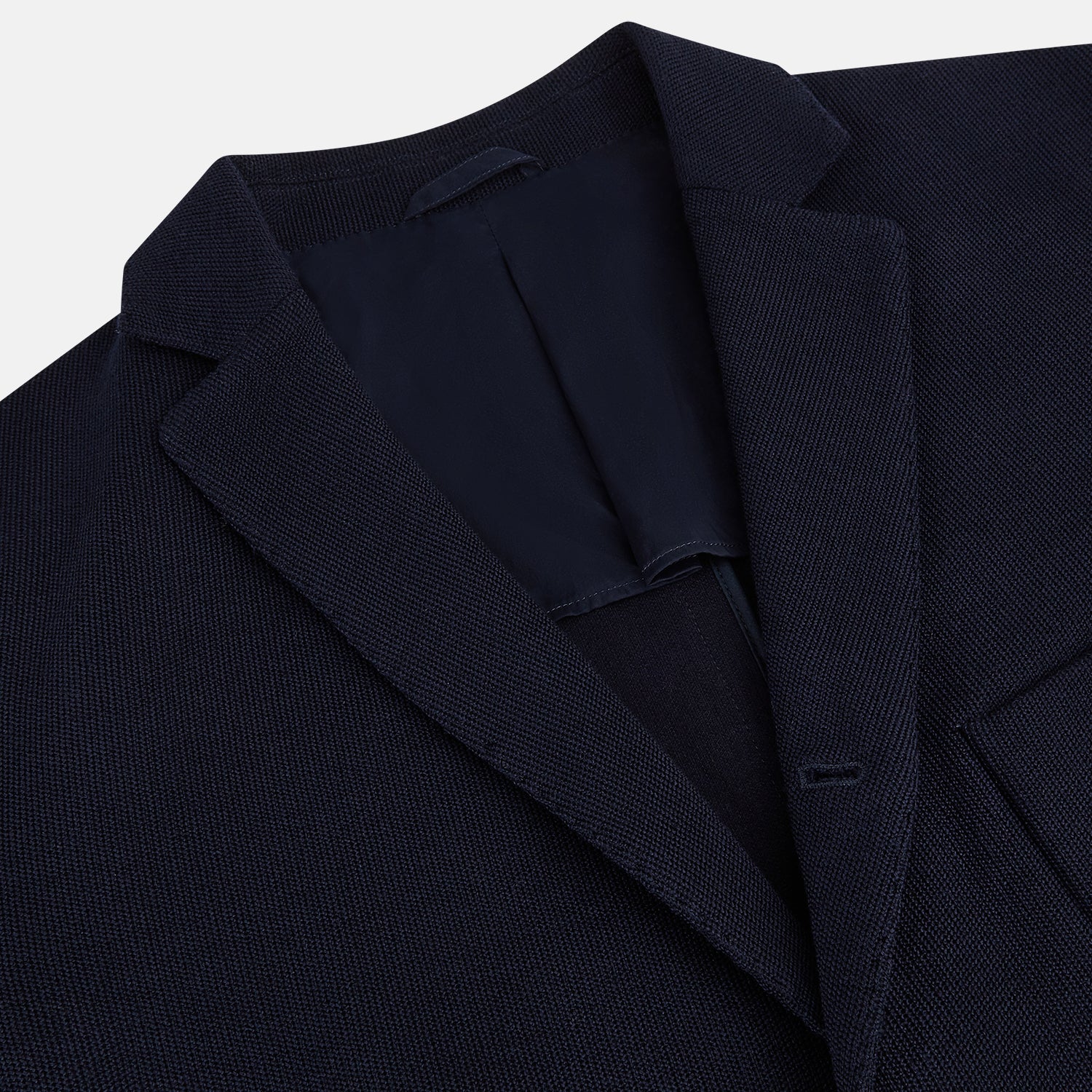 View 2 of product The Navy Knitted Oxford Blazer by Turnbull & Asser features notch lapels, two front buttons, a chest pocket, and two lower patch pockets, shown against a plain white background.