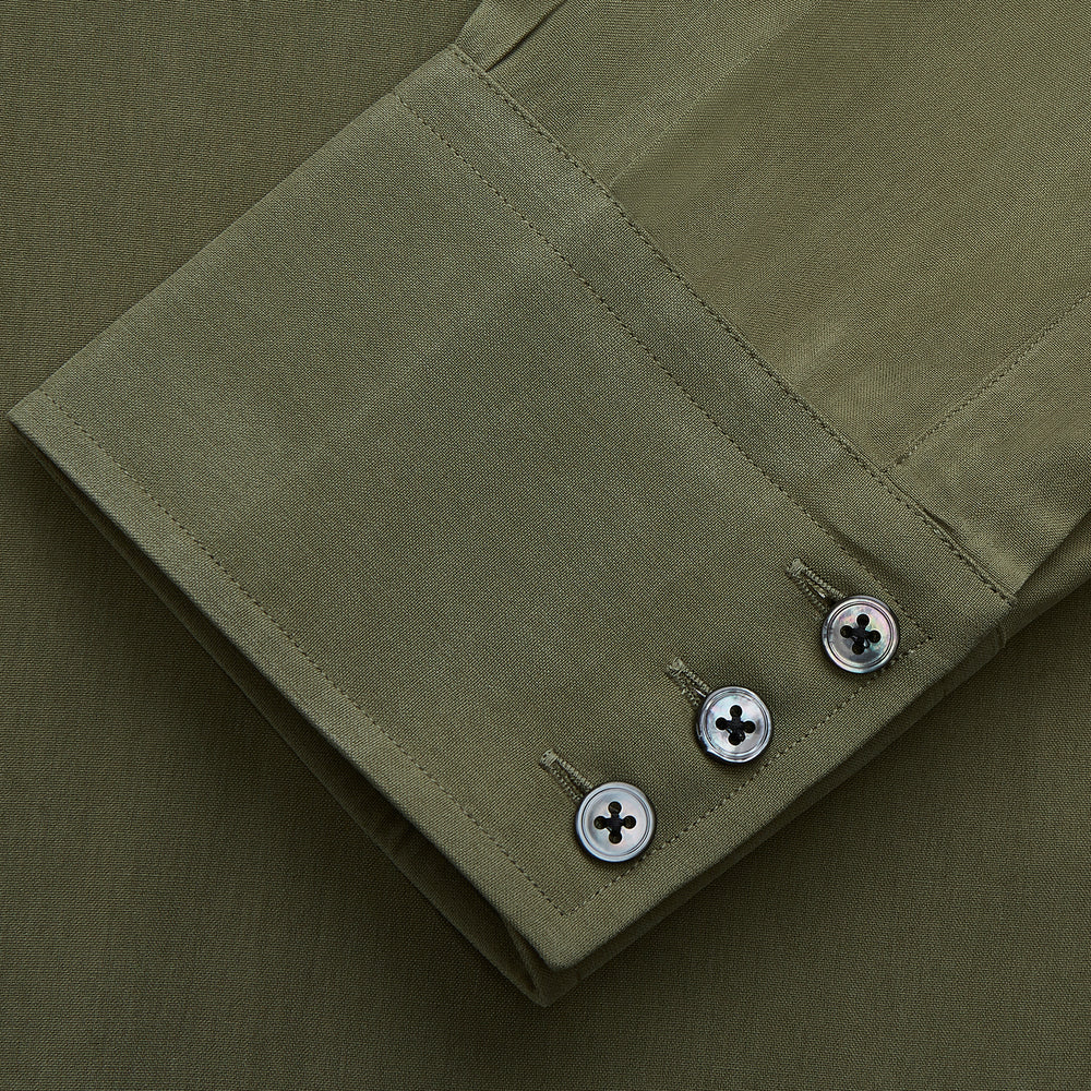 The Turnbull & Asser Green Silk Regular Fit Flaxton Shirt features long sleeves, a classic Bury collar, white buttons, and a straight hem, shown against a plain white background.