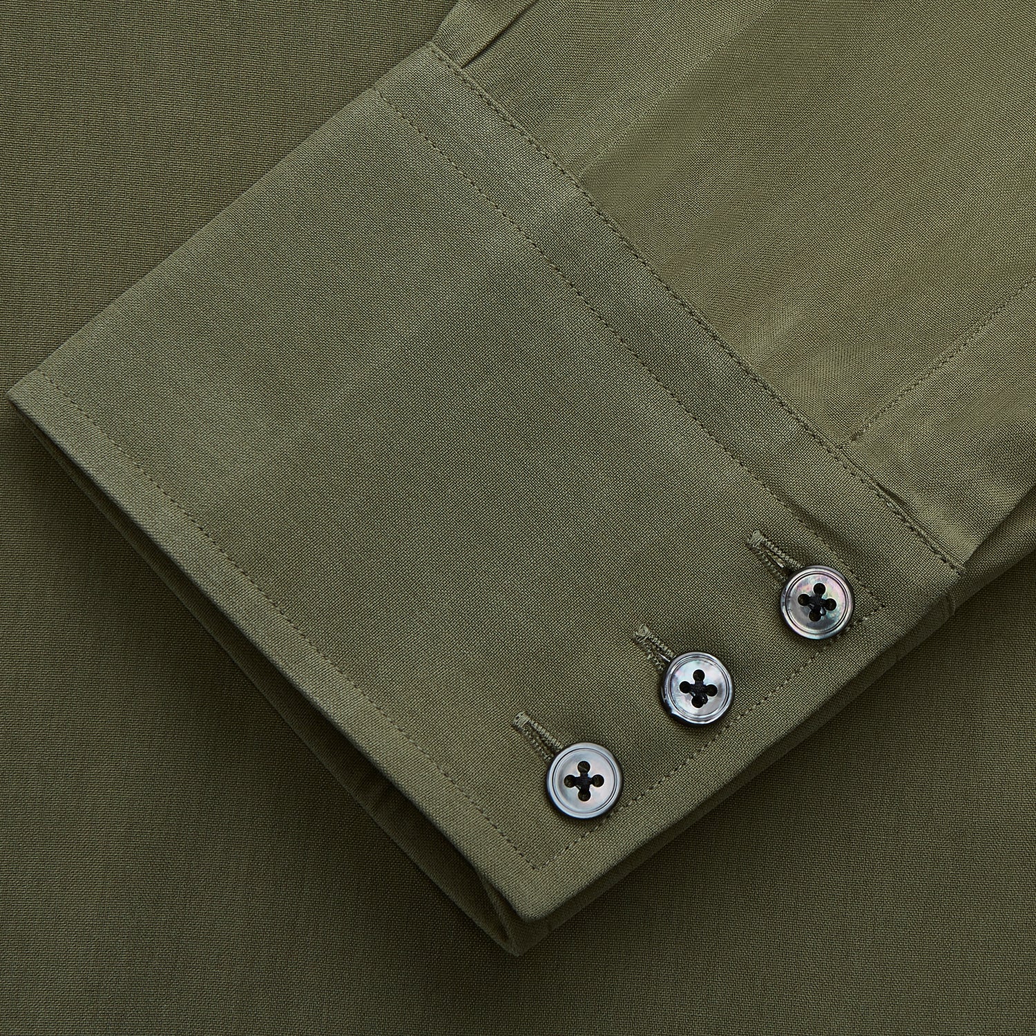 View 3 of product The Turnbull & Asser Green Silk Regular Fit Flaxton Shirt features long sleeves, a classic Bury collar, white buttons, and a straight hem, shown against a plain white background.