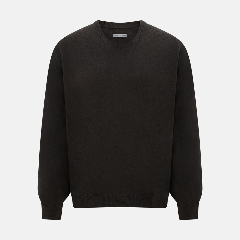 A plain, long-sleeved brown cashmere round neck jumper by Turnbull & Asser displayed on a white background. This men’s knitwear features ribbed cuffs, hem, and neckline with a relaxed fit and no visible patterns or logos.