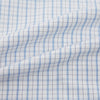 View 6 of product The Turnbull & Asser Sky Blue Combination Graph Check Mayfair Shirt features long sleeves, a pointed collar, buttoned cuffs, and a blue and white check pattern that showcases British craftsmanship. Displayed on a white background.