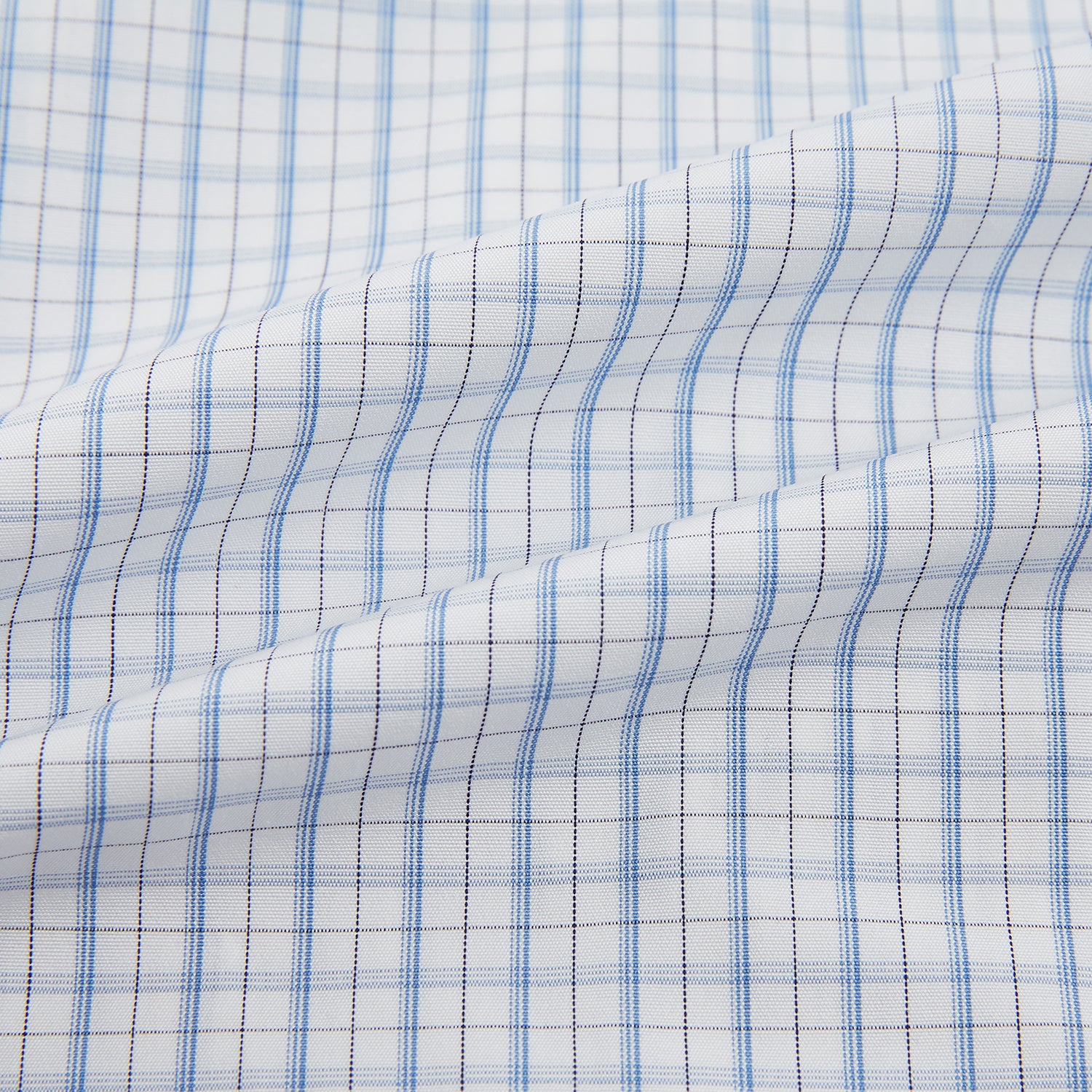 View 6 of product The Turnbull & Asser Sky Blue Combination Graph Check Mayfair Shirt features long sleeves, a pointed collar, buttoned cuffs, and a blue and white check pattern that showcases British craftsmanship. Displayed on a white background.