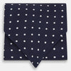 View 1 of product The White Dot and Navy Silk Cravat by Turnbull & Asser features evenly spaced white polka dots on navy silk—a classic accessory ideal for adding British elegance to any look.