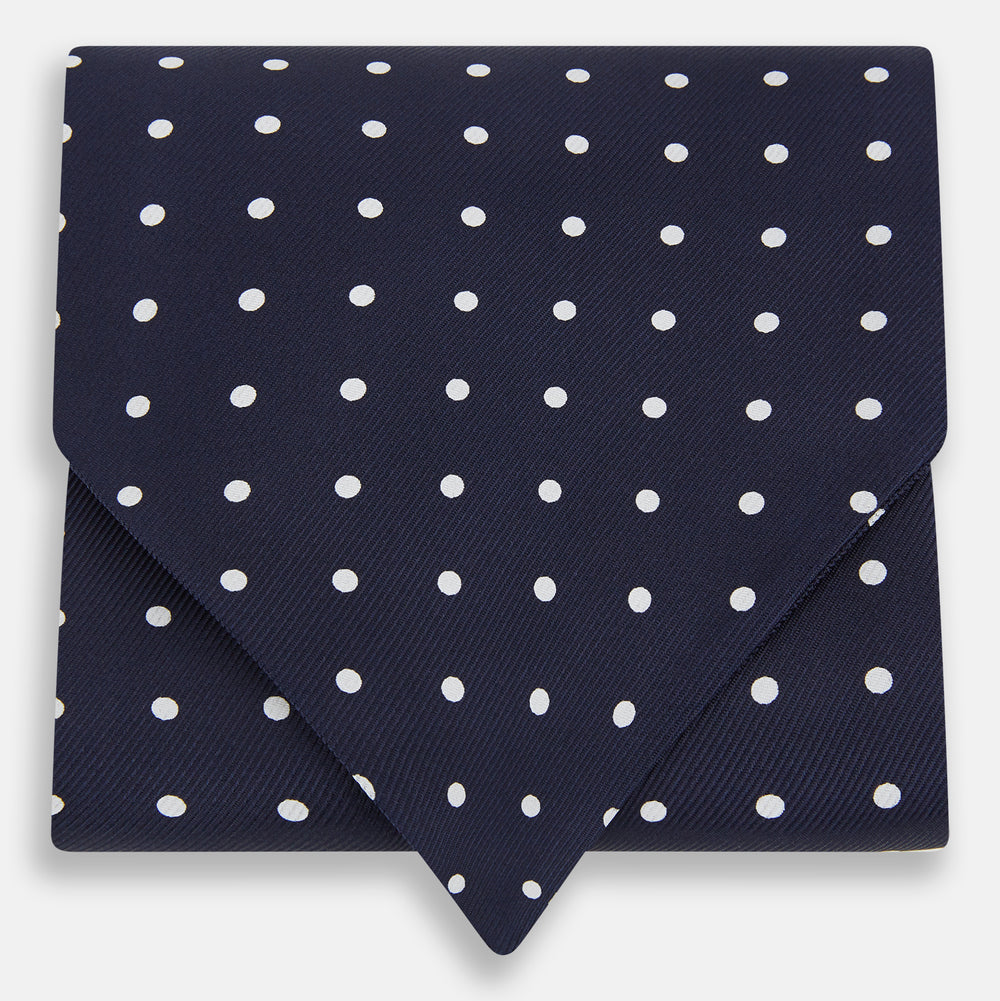 The White Dot and Navy Silk Cravat by Turnbull & Asser features evenly spaced white polka dots on navy silk—a classic accessory ideal for adding British elegance to any look.