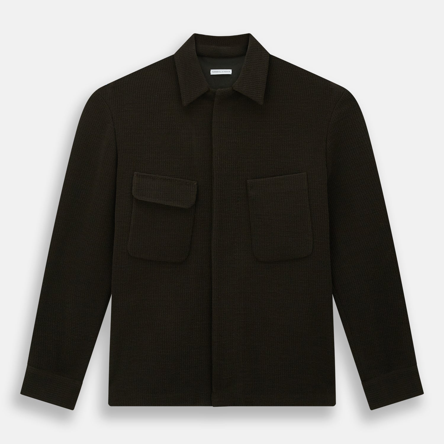 View 1 of product The Turnbull & Asser Dark Chocolate Greenwich Knitted Overshirt is crafted from Italian wool, with a classic collar, two flap chest pockets, and a concealed button front—offering a sleek cardigan alternative. Shown on a white background.