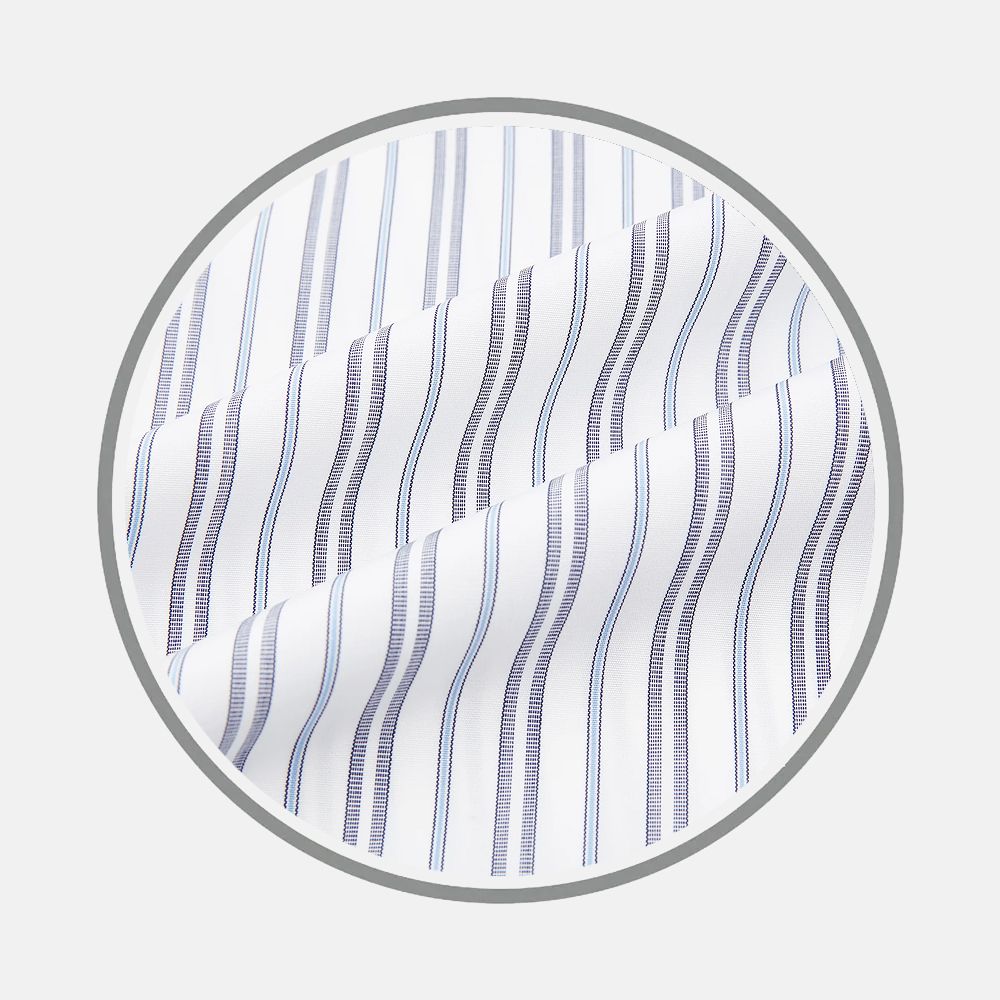 Turnbull & Asser's Navy And Light Blue Multi Track Stripe Fabric features smooth white fabric with vertical navy and light blue wavy stripes, displayed in a circular frame against a light gray background.