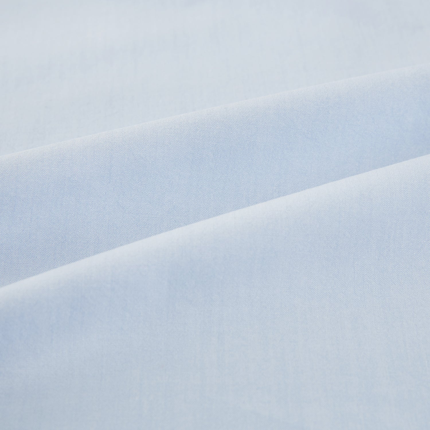 View 6 of product The Pale Blue Mayfair Shirt by Turnbull & Asser is a long-sleeve, button-up dress shirt with a pointed collar and buttoned cuffs, crafted from sanforised cotton and shown laid flat on a white background.