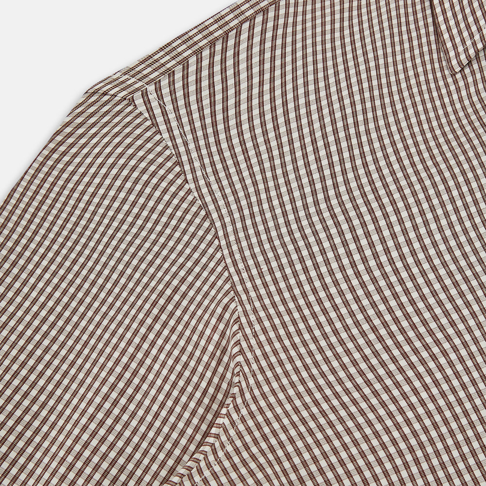 The Turnbull & Asser Burgundy Micro Check Westminster Shirt is a long-sleeved button-up with a classic collar and tailored fit, featuring a subtle micro check pattern, shown against a white background.