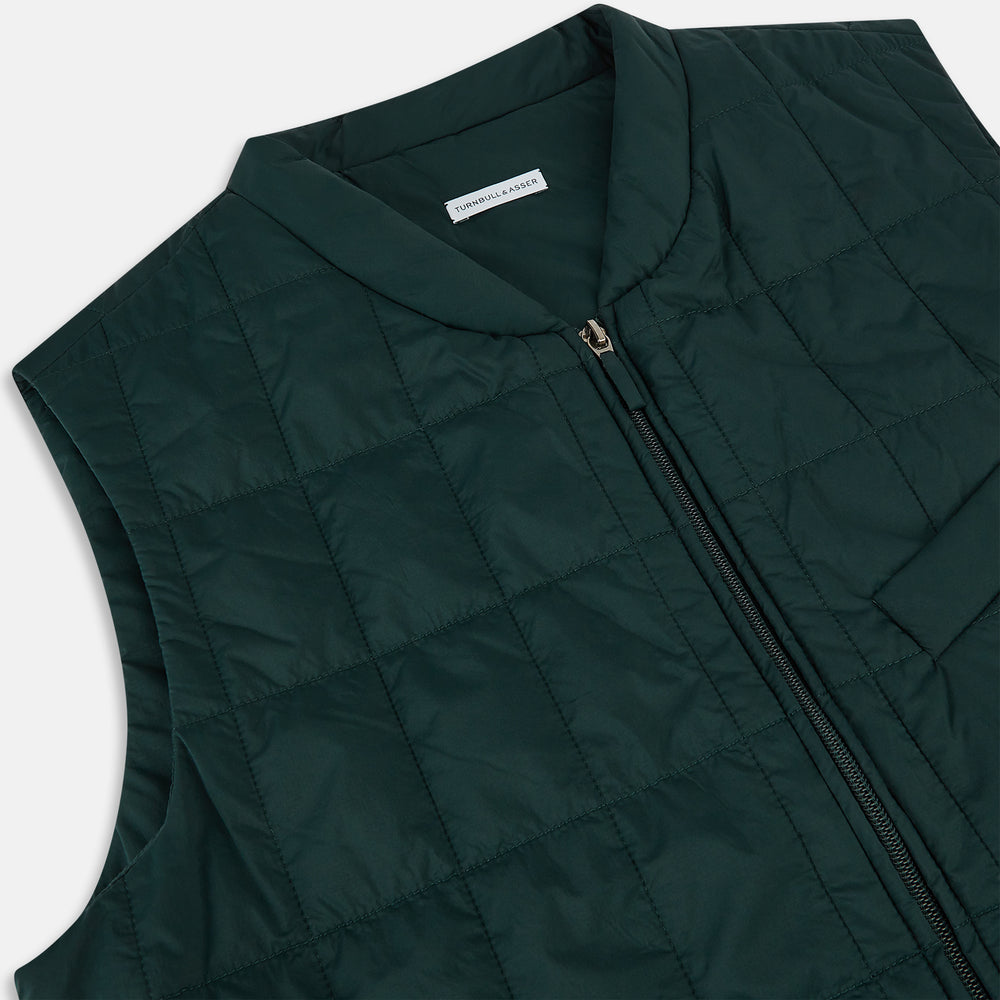 Turnbull & Asser Forest Green Quilted Gilet features a front zipper, two zippered side pockets, and a small chest pocket. Shown against a white background, it's a stylish lightweight layer for any season.