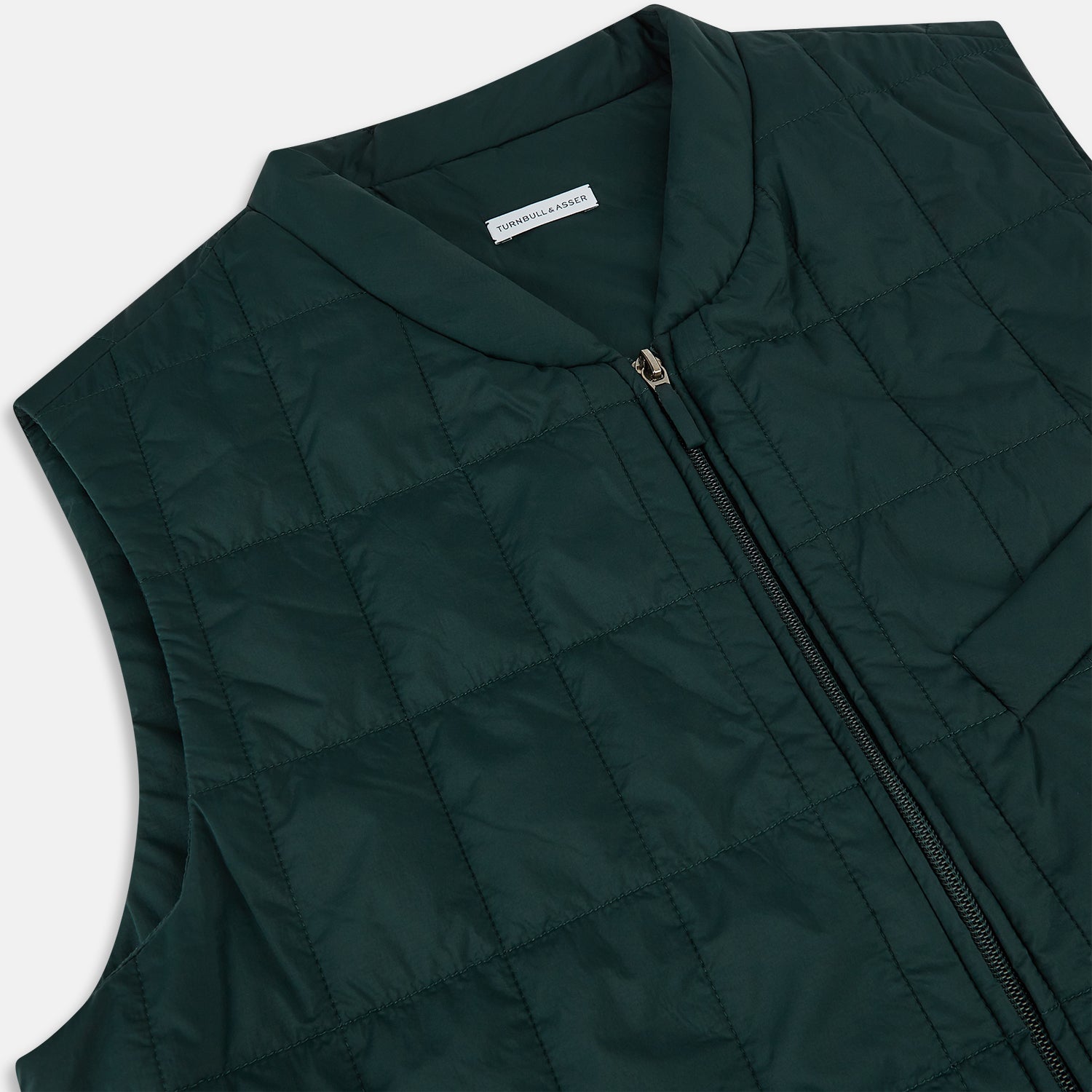 View 2 of product Turnbull & Asser Forest Green Quilted Gilet features a front zipper, two zippered side pockets, and a small chest pocket. Shown against a white background, it's a stylish lightweight layer for any season.