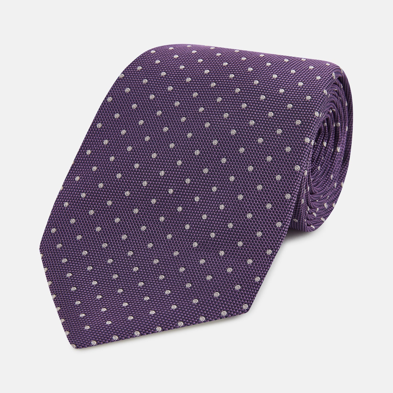View 1 of product The Turnbull & Asser Lavender and Purple Micro Dot Silk Tie is displayed rolled-up against a plain white background.