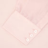 View 4 of product The Turnbull & Asser Pink Cashmere Blend Shirt features a T&A collar and 3-button cuffs, neatly folded with white buttons, displayed on a plain white background.