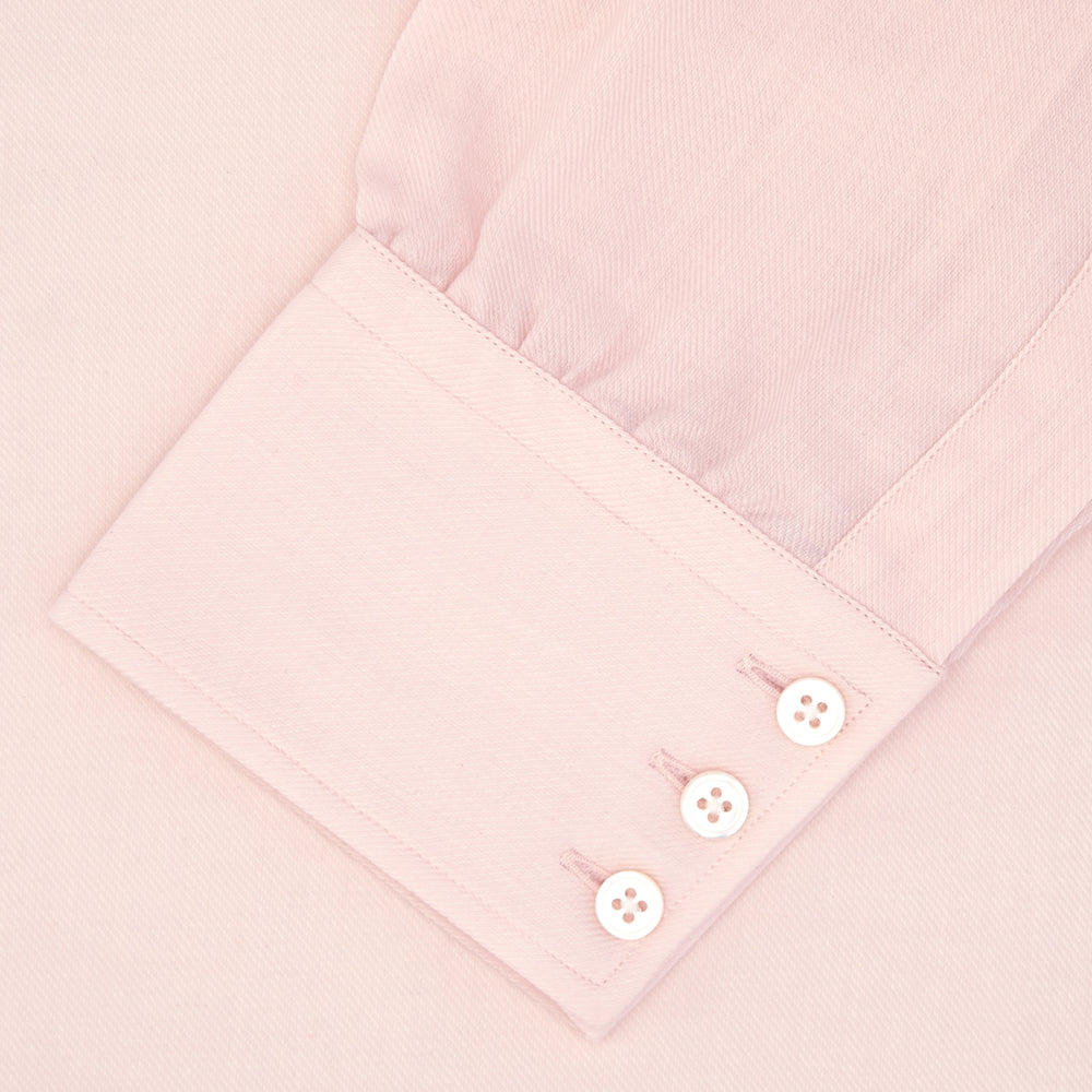 The Turnbull & Asser Pink Cashmere Blend Shirt features a T&A collar and 3-button cuffs, neatly folded with white buttons, displayed on a plain white background.