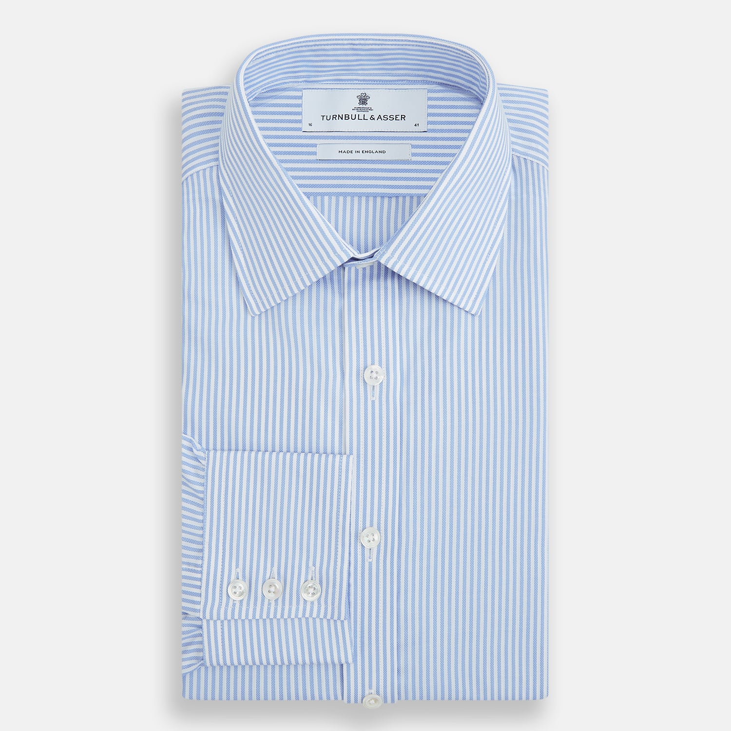 View 5 of product The Turnbull & Asser Blue Bengal Stripe Mayfair Shirt features light blue and white vertical stripes, a classic T&A collar, white buttons, and buttoned cuffs. Laid flat on a white background.