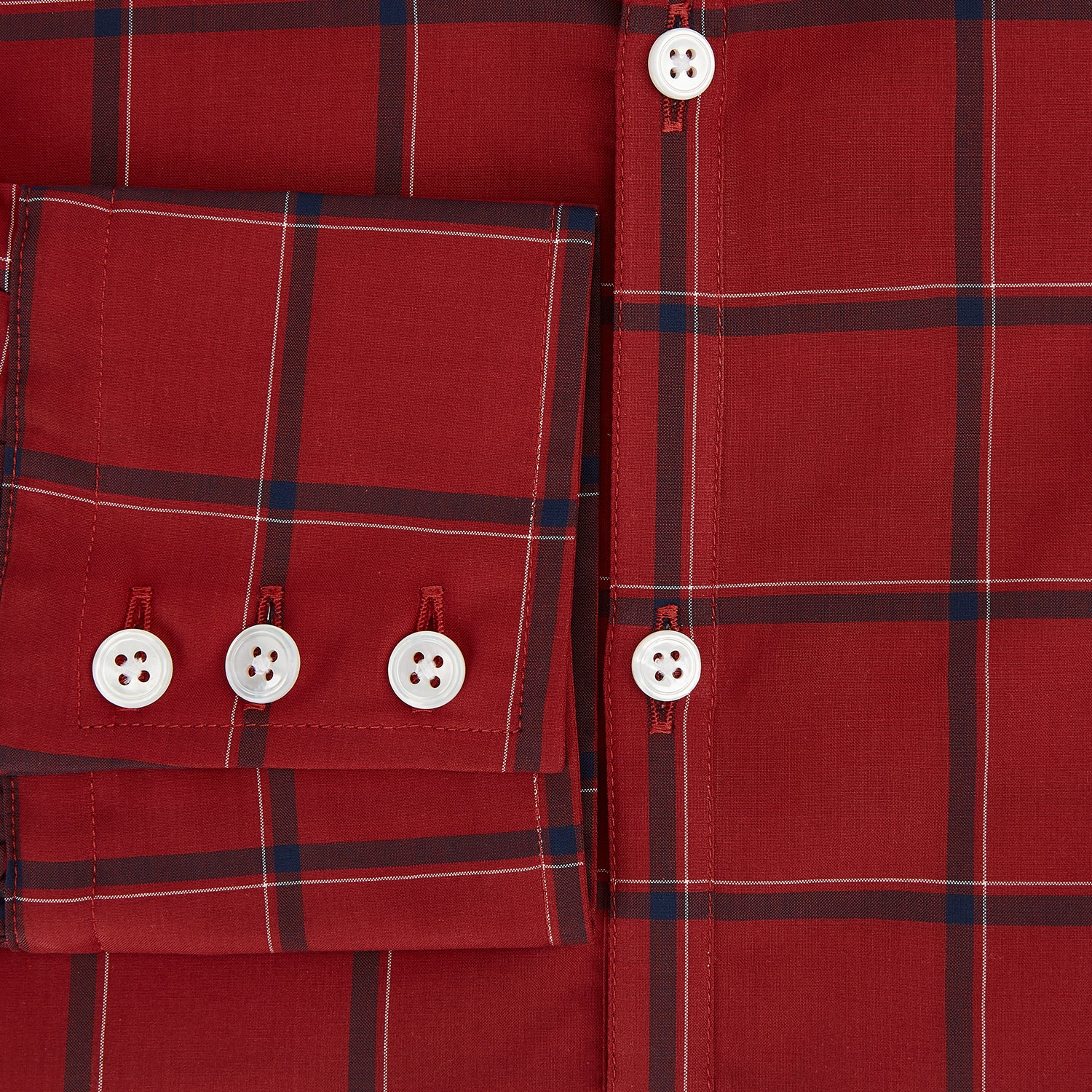 View 4 of product The Turnbull & Asser Dark Red Grid Check Windsor Shirt is a long-sleeved, button-up shirt with a dark red base and black and white grid pattern, displayed flat on a white background.