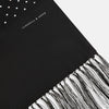 View 2 of product The Turnbull & Asser Black and White Spotted Silk Scarf with Fringes features a classic polka dot design, silver fringe edges, and the brand name printed near each end.