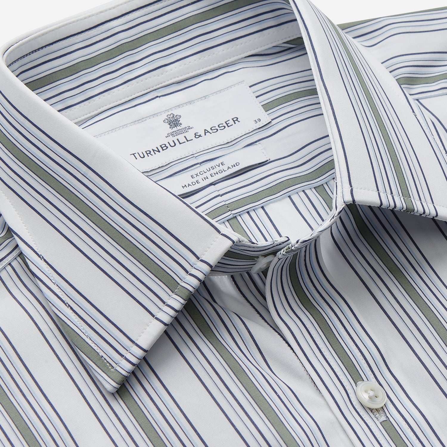 View 2 of product The Turnbull & Asser Green Multi Stripe Regular Fit Shirt features a T&A collar, 3 button cuffs, long sleeves, and vertical blue, green, and white stripes. Laid flat on a white background.