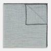 View 1 of product A neatly folded green cotton-blend Turnbull & Asser handkerchief with visible hand-rolled edges and one corner flipped over, showing the reverse side.