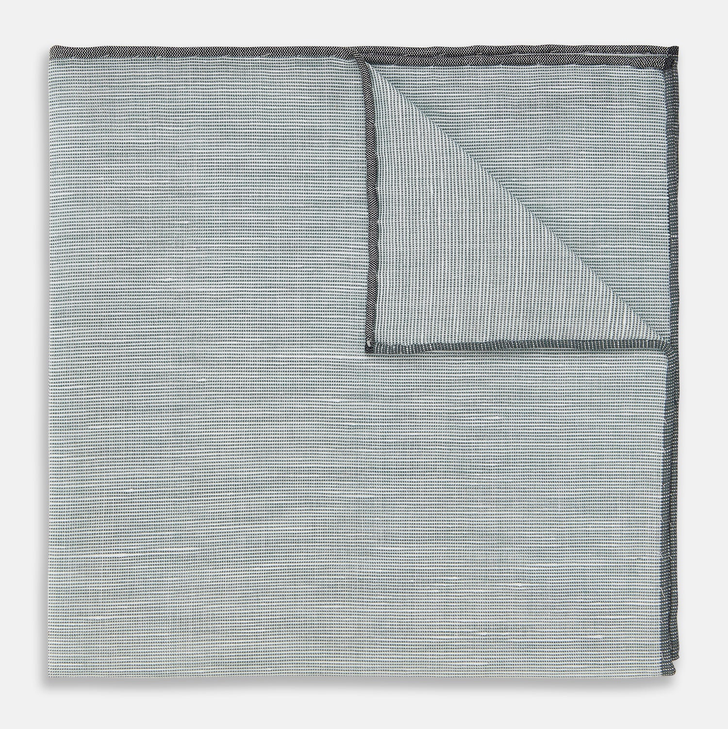 View 1 of product A neatly folded green cotton-blend Turnbull & Asser handkerchief with visible hand-rolled edges and one corner flipped over, showing the reverse side.