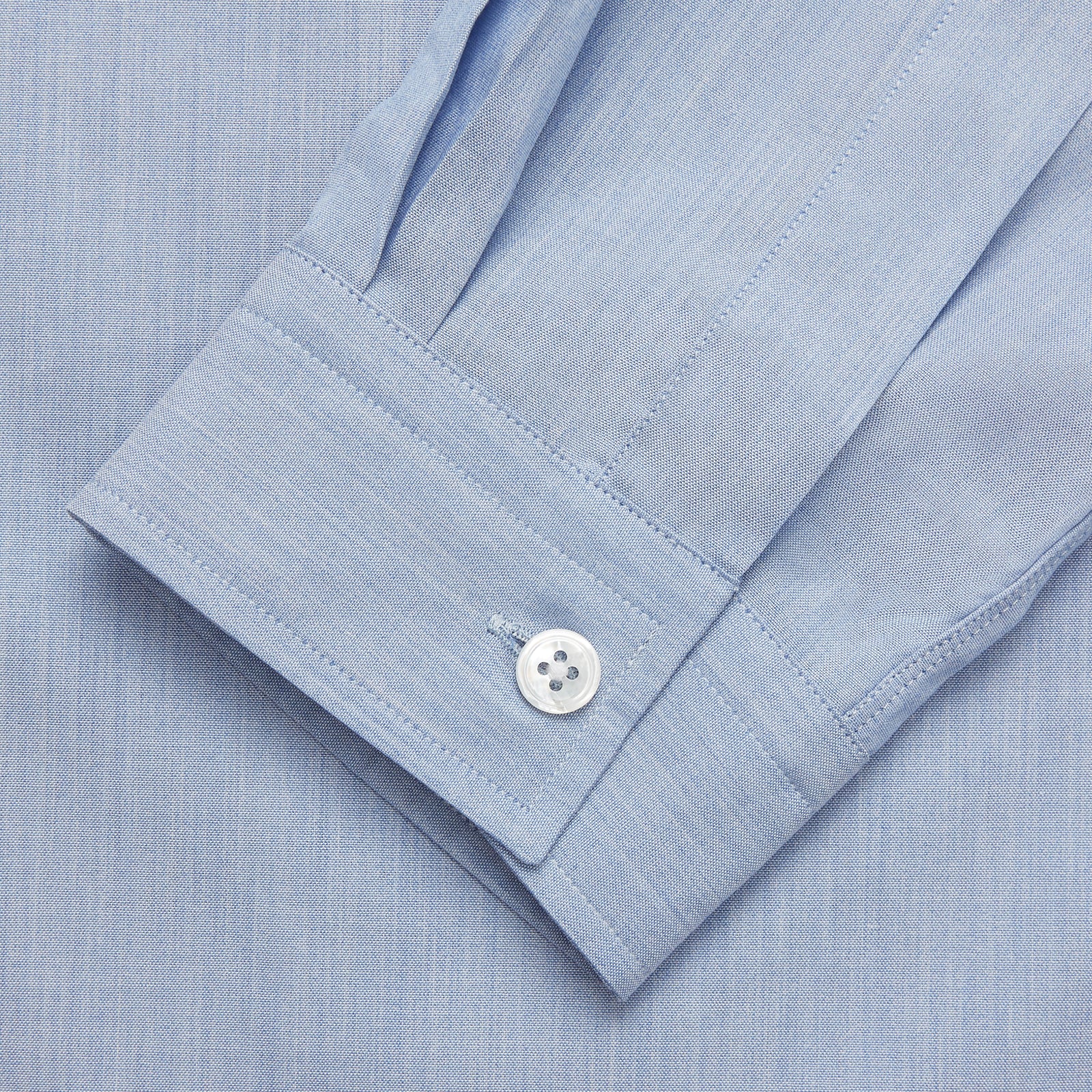 View 2 of product The Turnbull & Asser Slate Blue Chambray Holiday Fit Fellows Shirt features long sleeves and a classic collar, laid flat on a white background—a versatile summer piece for any occasion.