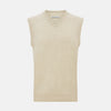 View 1 of product The Turnbull & Asser Cream Cashmere V-neck Vest features a sleeveless design and ribbed hem, presented on a plain white background—a refined update to the classic men’s sweater.