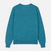 View 3 of product The Teal Paden V-Neck Jumper by Turnbull & Asser is a pure cashmere sweater in teal blue, featuring long sleeves with ribbed cuffs and hem, shown flat on a light gray background.