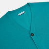 View 2 of product The Turnbull & Asser Turquoise Fine Merino V-Neck Cardigan features long sleeves, ribbed cuffs and hem, and black buttons, showcased against a plain white background.