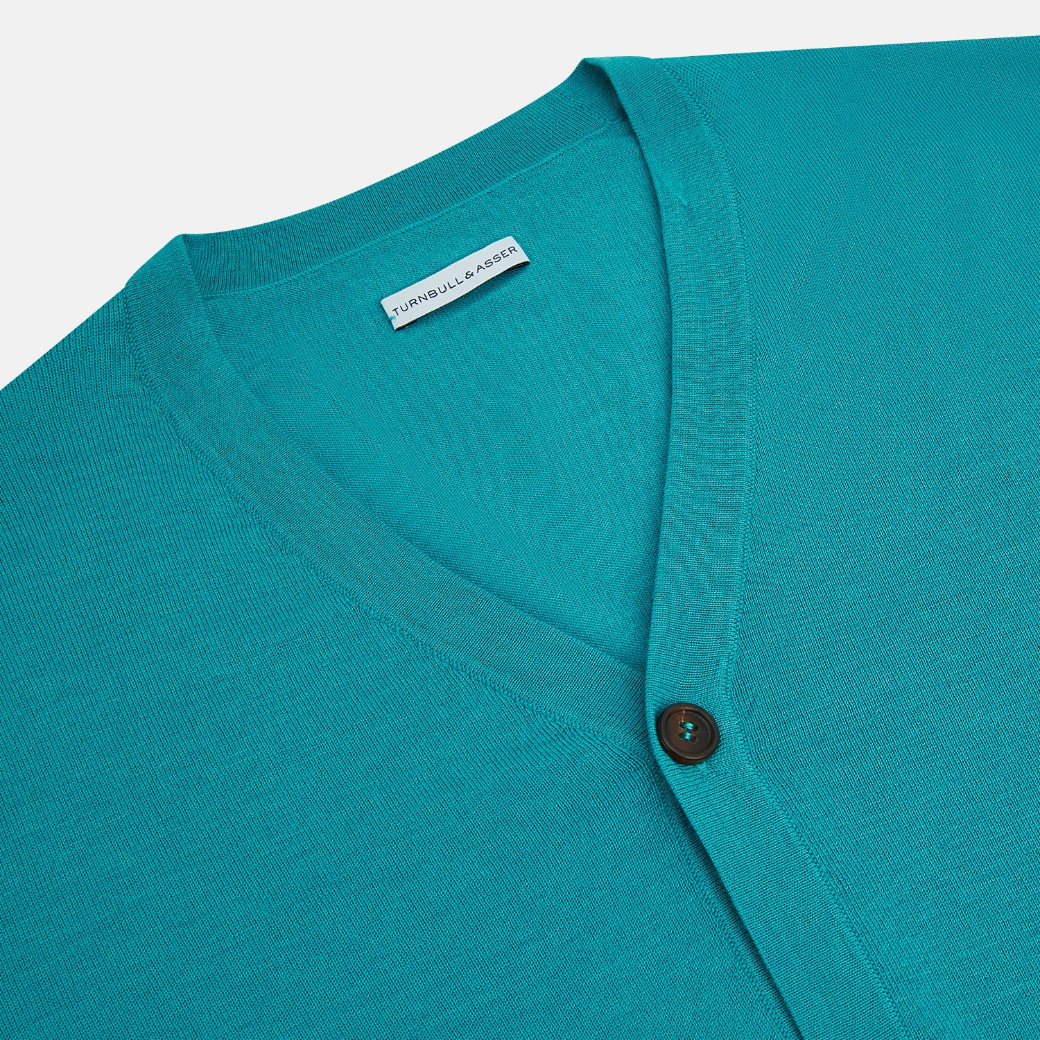 View 2 of product The Turnbull & Asser Turquoise Fine Merino V-Neck Cardigan features long sleeves, ribbed cuffs and hem, and black buttons, showcased against a plain white background.