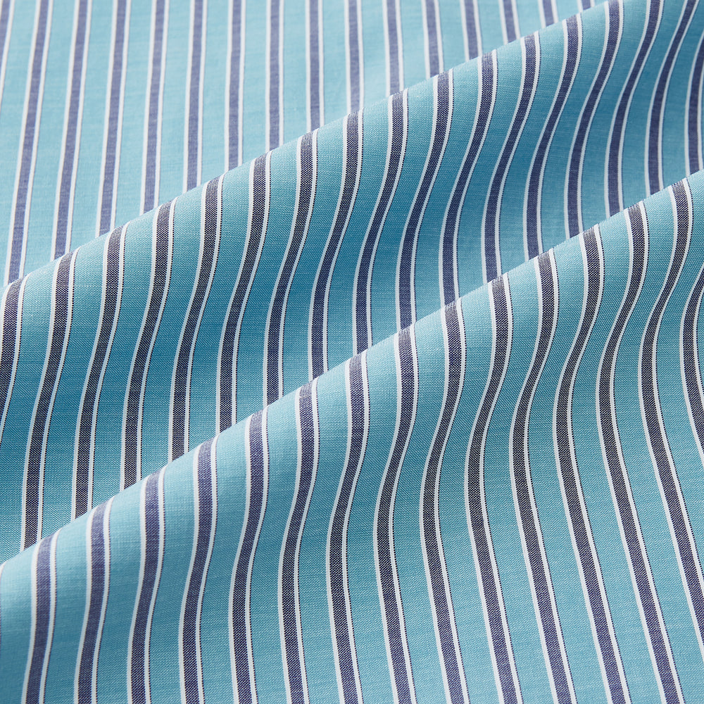The Turnbull & Asser Turquoise Ticking Stripe Mayfair Shirt is a long-sleeve, button-up shirt in fine Italian cotton with light blue and white stripes, a collar, white buttons, curved hem, and subtle turquoise ticking stripe.