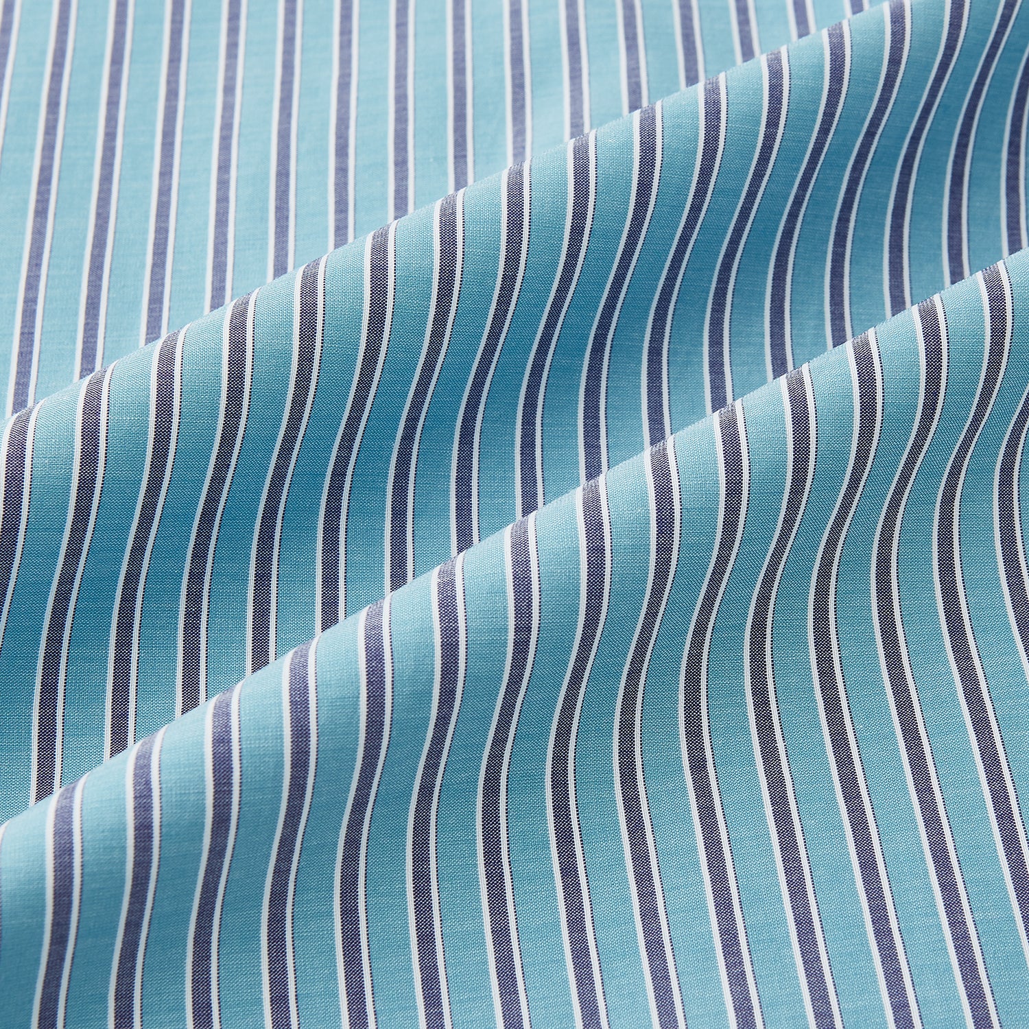 View 6 of product The Turnbull & Asser Turquoise Ticking Stripe Mayfair Shirt is a long-sleeve, button-up shirt in fine Italian cotton with light blue and white stripes, a collar, white buttons, curved hem, and subtle turquoise ticking stripe.