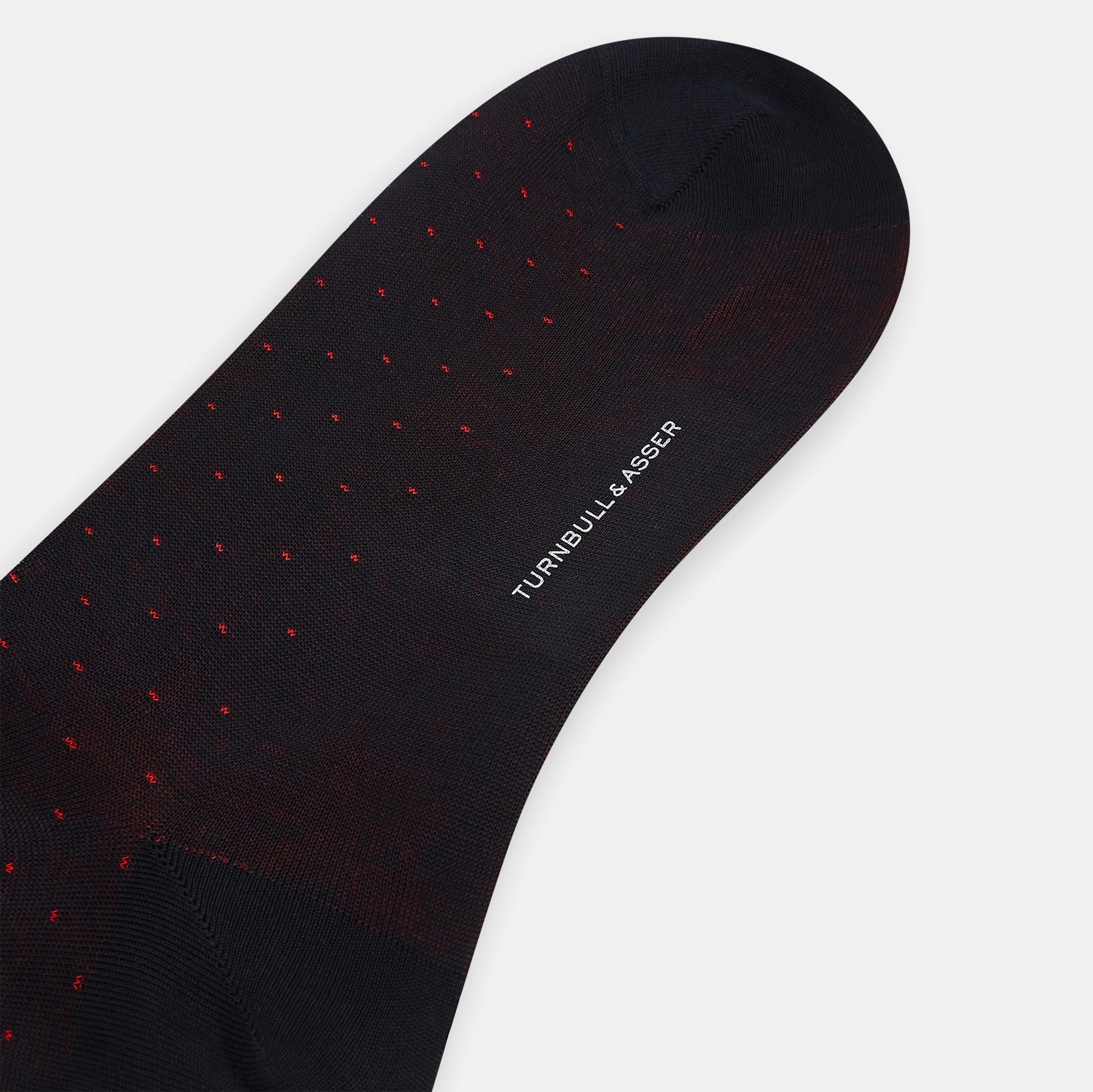 View 3 of product A single Turnbull & Asser Navy/Red Polka Dot Long Sock, crafted from mercerised Egyptian cotton, is displayed against a plain white background.