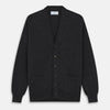 View 1 of product The Turnbull & Asser Charcoal Lachlan Cashmere Cardigan features long sleeves, a V-neck, button-down front, two pockets, and ribbed cuffs—ideal for smart-casual layering—shown laid flat on a white background.
