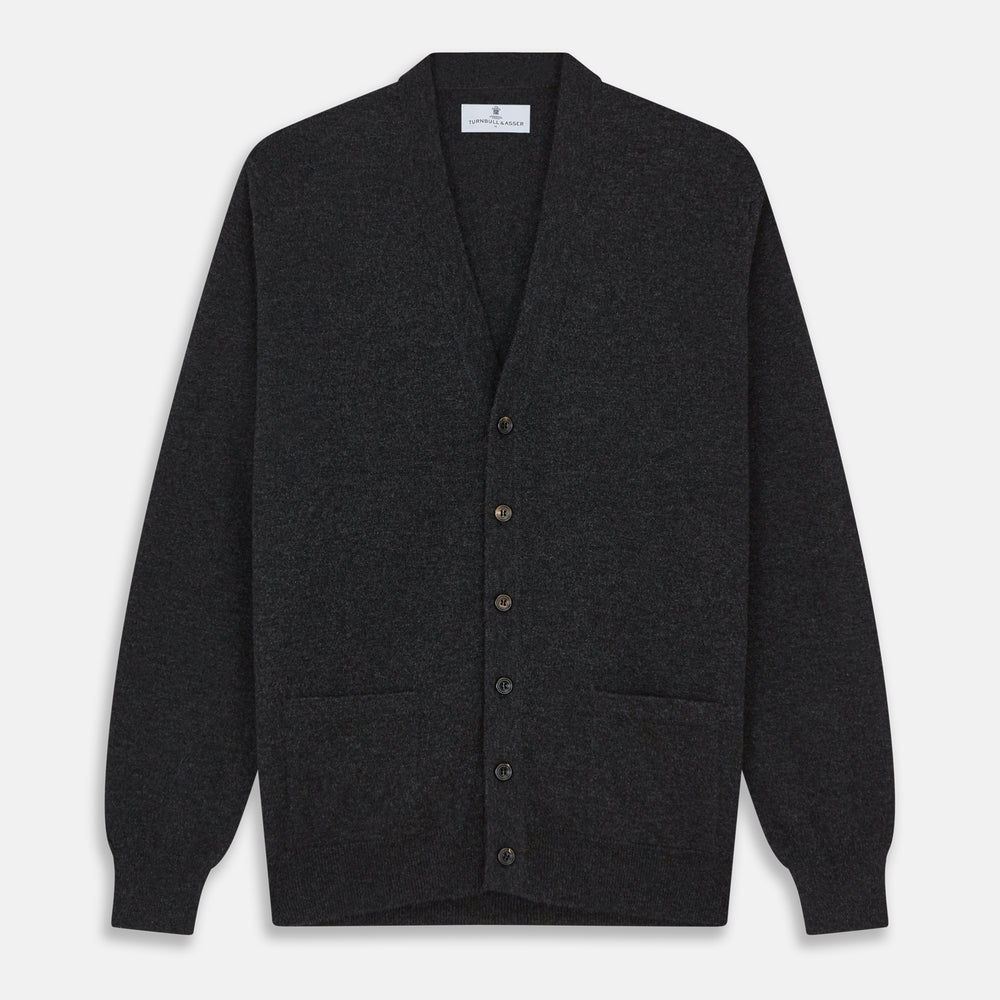 The Turnbull & Asser Charcoal Lachlan Cashmere Cardigan features long sleeves, a V-neck, button-down front, two pockets, and ribbed cuffs—ideal for smart-casual layering—shown laid flat on a white background.