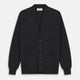 The Turnbull & Asser Charcoal Lachlan Cashmere Cardigan features long sleeves, a V-neck, button-down front, two pockets, and ribbed cuffs—ideal for smart-casual layering—shown laid flat on a white background.