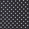 View 3 of product The Turnbull & Asser Black and White Small Spot Printed Silk Tie, shown rolled against a white background, features a subtle polka dot pattern—an ideal accessory for any office shirt.