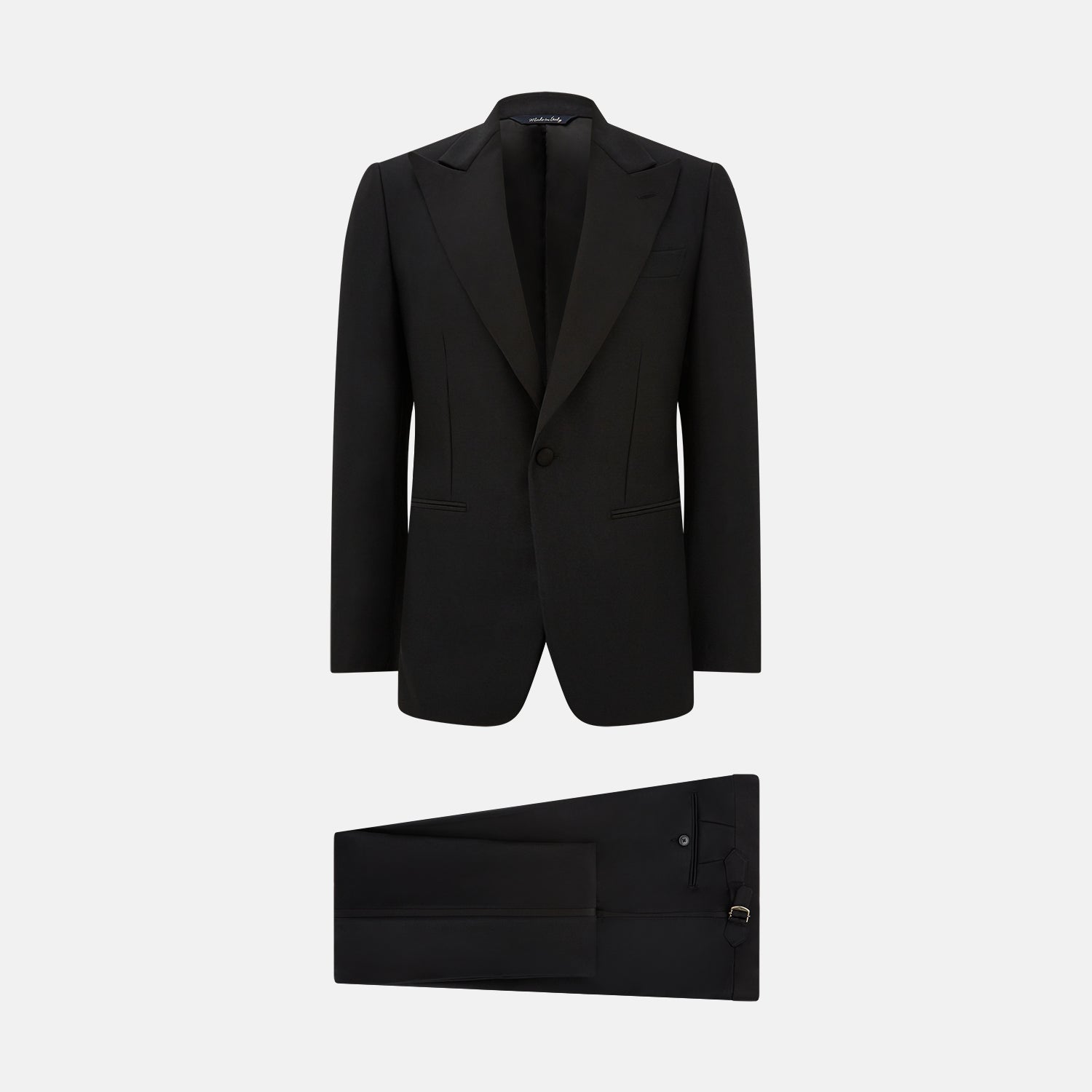 View 9 of product The Turnbull & Asser Black Single Breasted Dinner Suit, with satin lapels and matching trousers, is elegantly folded and displayed on a plain white background.