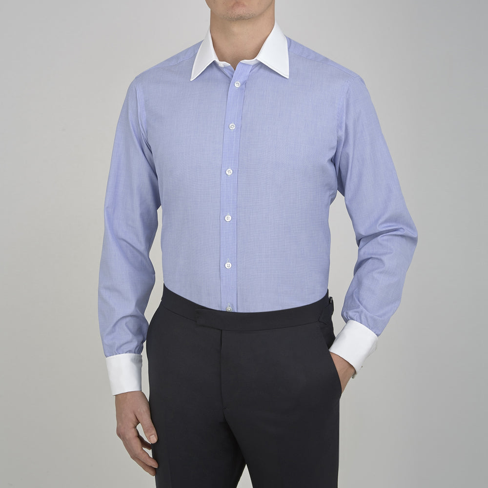 The Wall Street Shirt with White T&A Collar by Turnbull & Asser, as seen on Gordon Gekko, is folded neatly to showcase its light purple color, crisp French cuffs, and iconic contrasting collar against a plain background.