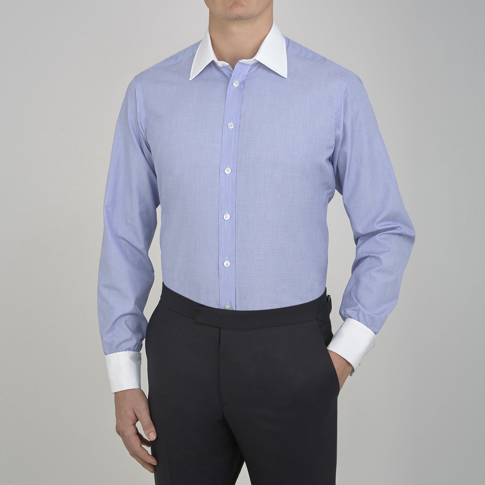 View 2 of product The Wall Street Shirt with White T&A Collar by Turnbull & Asser, as seen on Gordon Gekko, is folded neatly to showcase its light purple color, crisp French cuffs, and iconic contrasting collar against a plain background.