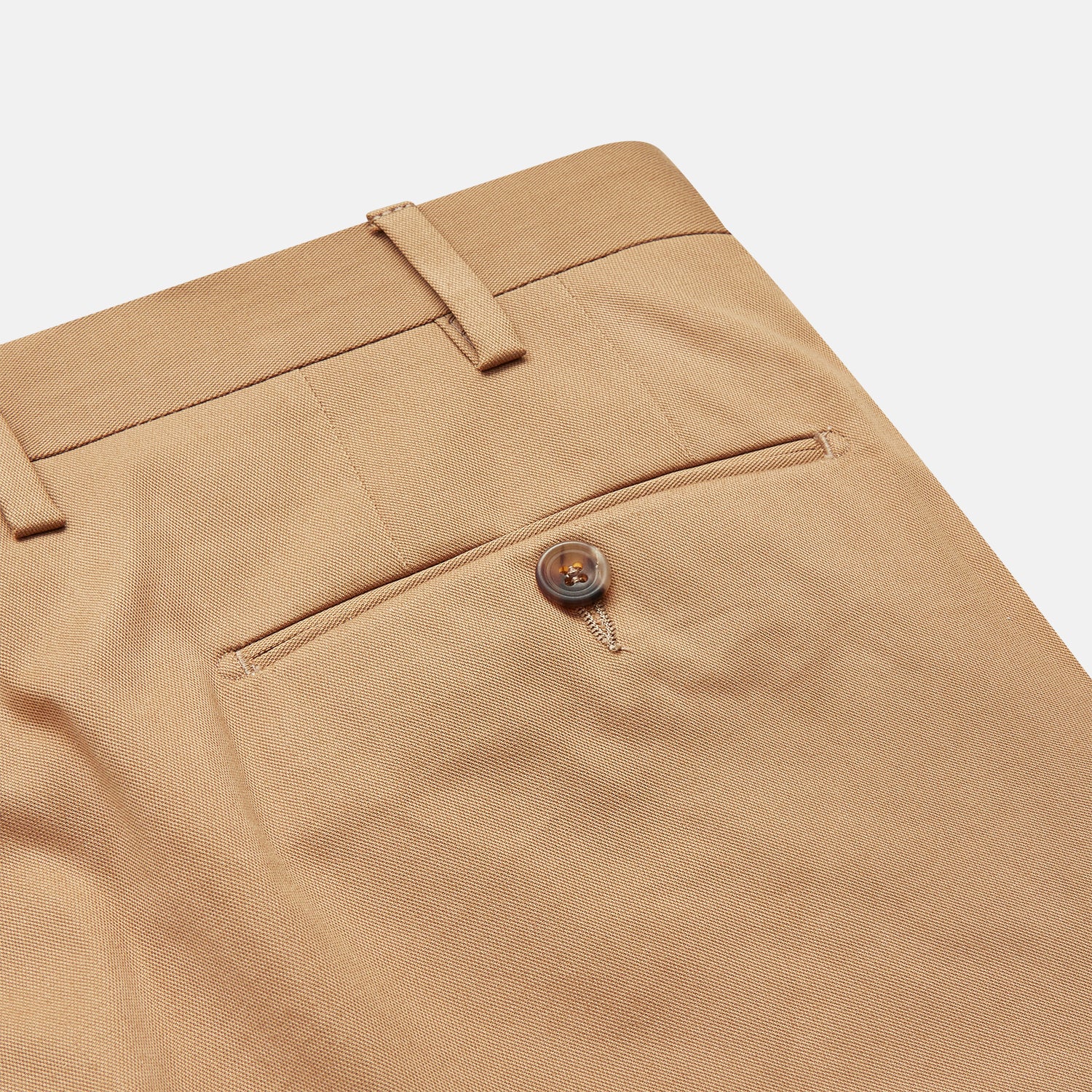 View 2 of product The Camel Front Pleated Manson Trouser by Turnbull & Asser, tailored in Italy with belt loops, front crease, side pockets, and a button closure, is shown laid flat on a white background.