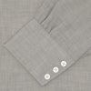 View 4 of product The Turnbull & Asser Grey Cashmere Blend Shirt features a T&A collar, 3-button cuffs, and a front pocket, shown neatly folded with white buttons against a plain white background.