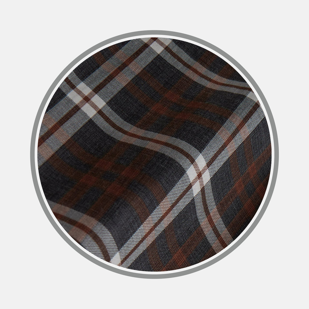 Close-up of Turnbull & Asser's Rust Check Cotton Fabric, featuring intersecting brown, black, and white stripes in a plaid pattern, displayed within a circular frame on a plain light gray background.