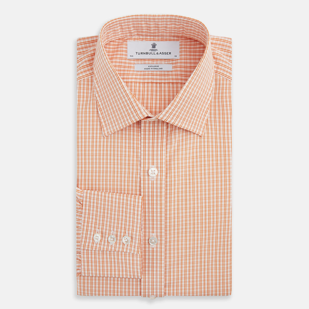 The Turnbull & Asser Orange Micro Check Mayfair Shirt, a long-sleeve button-up with a classic T&A collar and white-orange micro check pattern, is shown neatly laid flat on a white background.