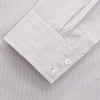 View 3 of product The Turnbull & Asser Sandstone Multi Stripe Cotton Tailored Fit Shelton Shirt features subtle vertical stripes, a pointed collar, and long sleeves, shown flat on a plain white background.