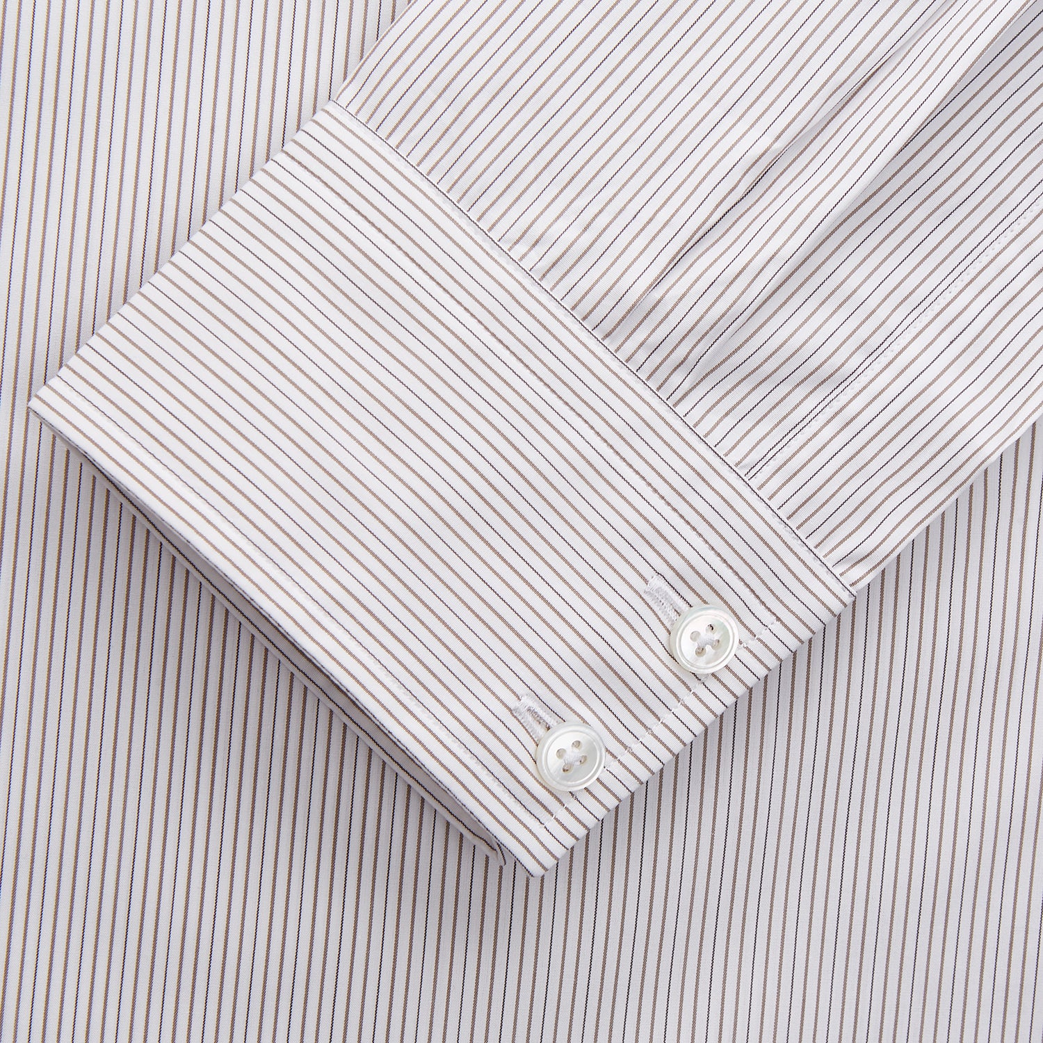 View 3 of product The Turnbull & Asser Sandstone Multi Stripe Cotton Tailored Fit Shelton Shirt features subtle vertical stripes, a pointed collar, and long sleeves, shown flat on a plain white background.